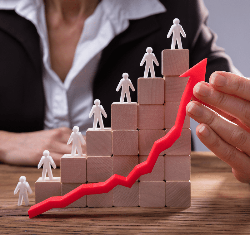 Red arrow and figures on wooden blocks.