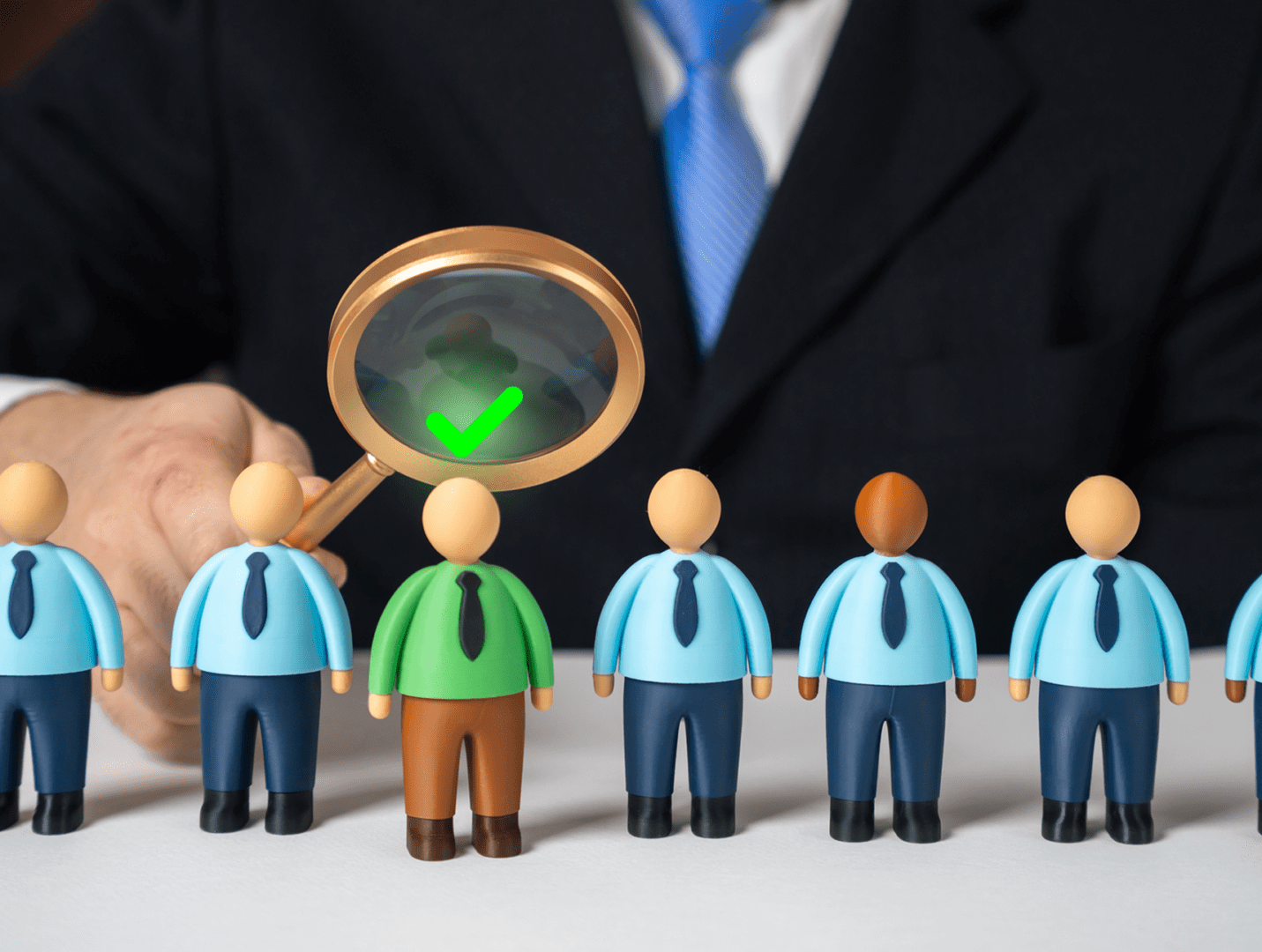 Magnifying glass selecting person with checkmark.